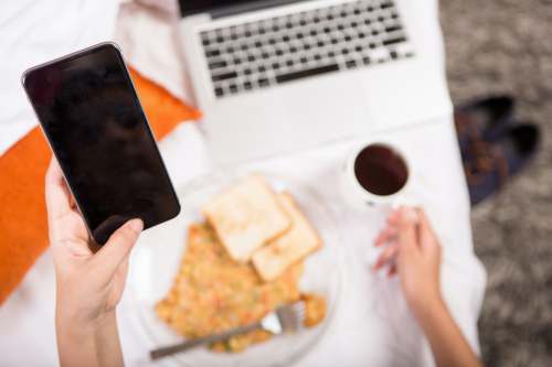 work from anywhere person holding black android smartphone technology